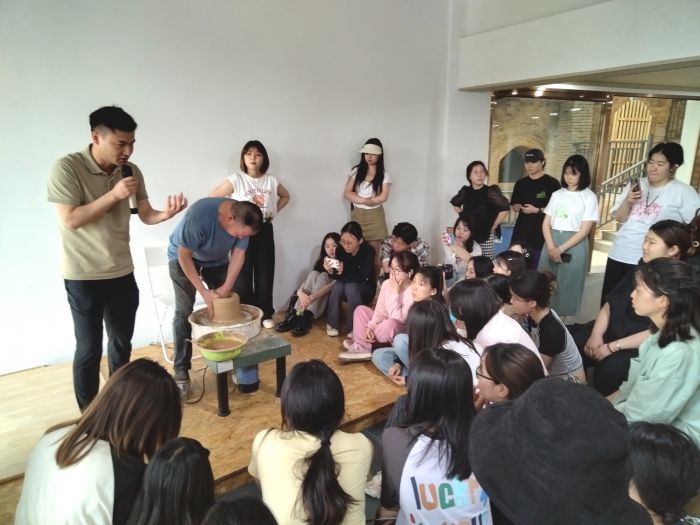 邓双在向大学生们介绍隆昌土陶制作技艺.jpg